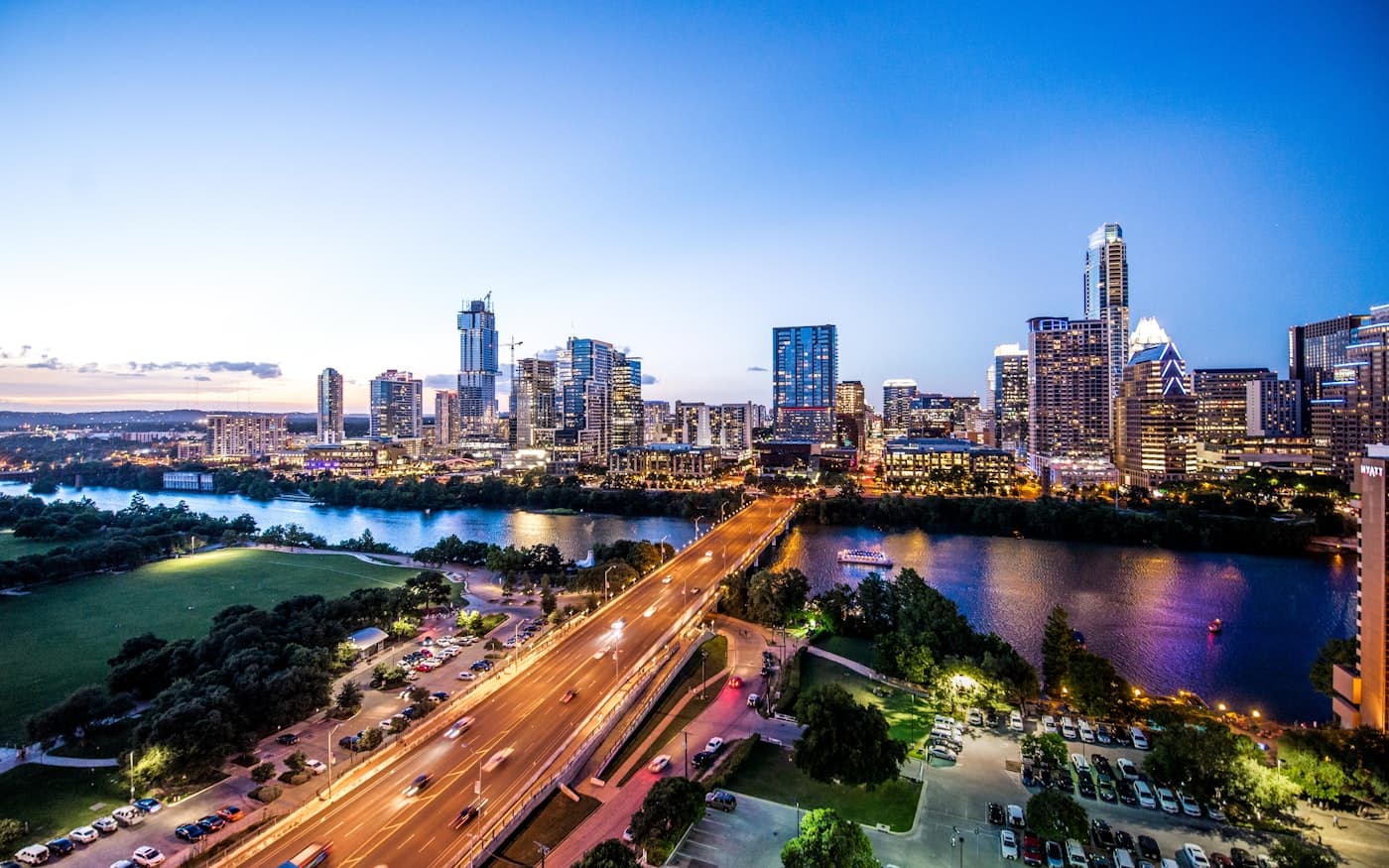 Austin, Texas at dusk, looking across Lady Bird Lake toward downtown